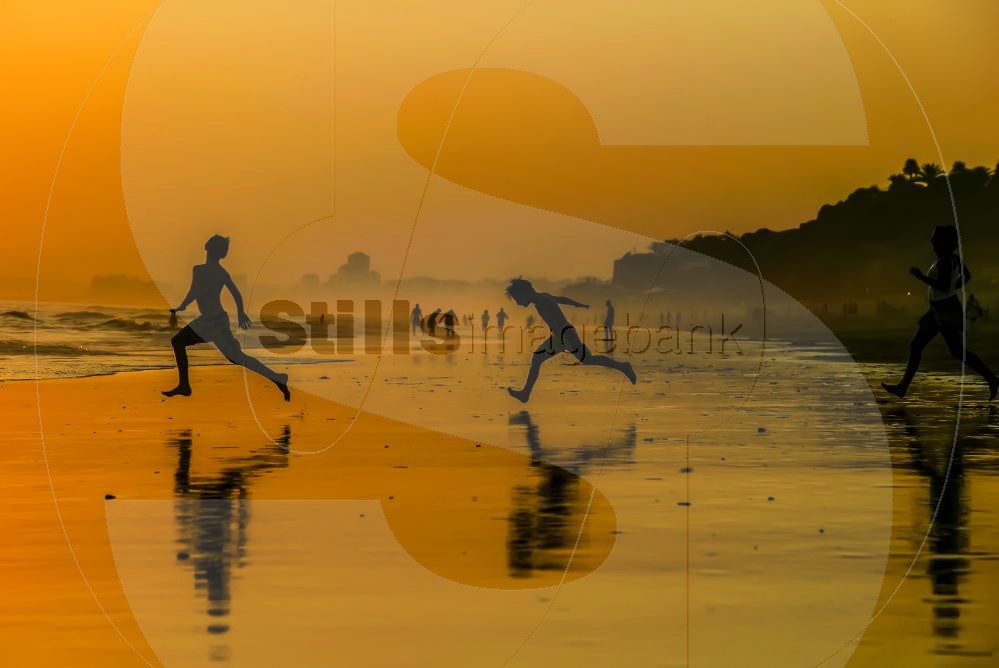 Playing on the beach at sunset