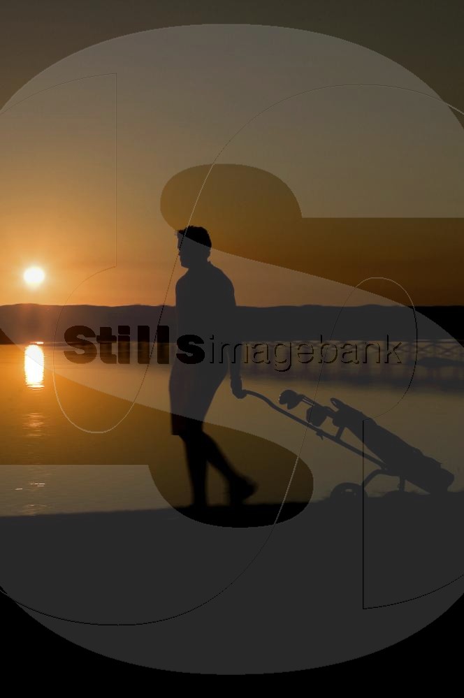Golf player at sunset
