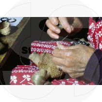 Women artisan sewing a doll