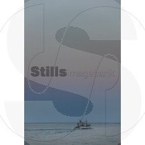 Fishing boat exiting to the sea at dawn