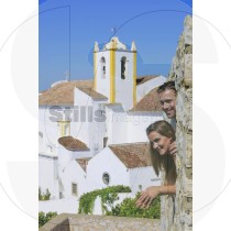 Couple watches the landscape trough the walls of Tavira's castle