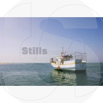 Fishing boat in Ria Formosa facing the sea