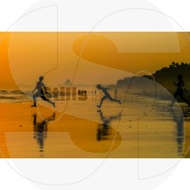 Playing on the beach at sunset
